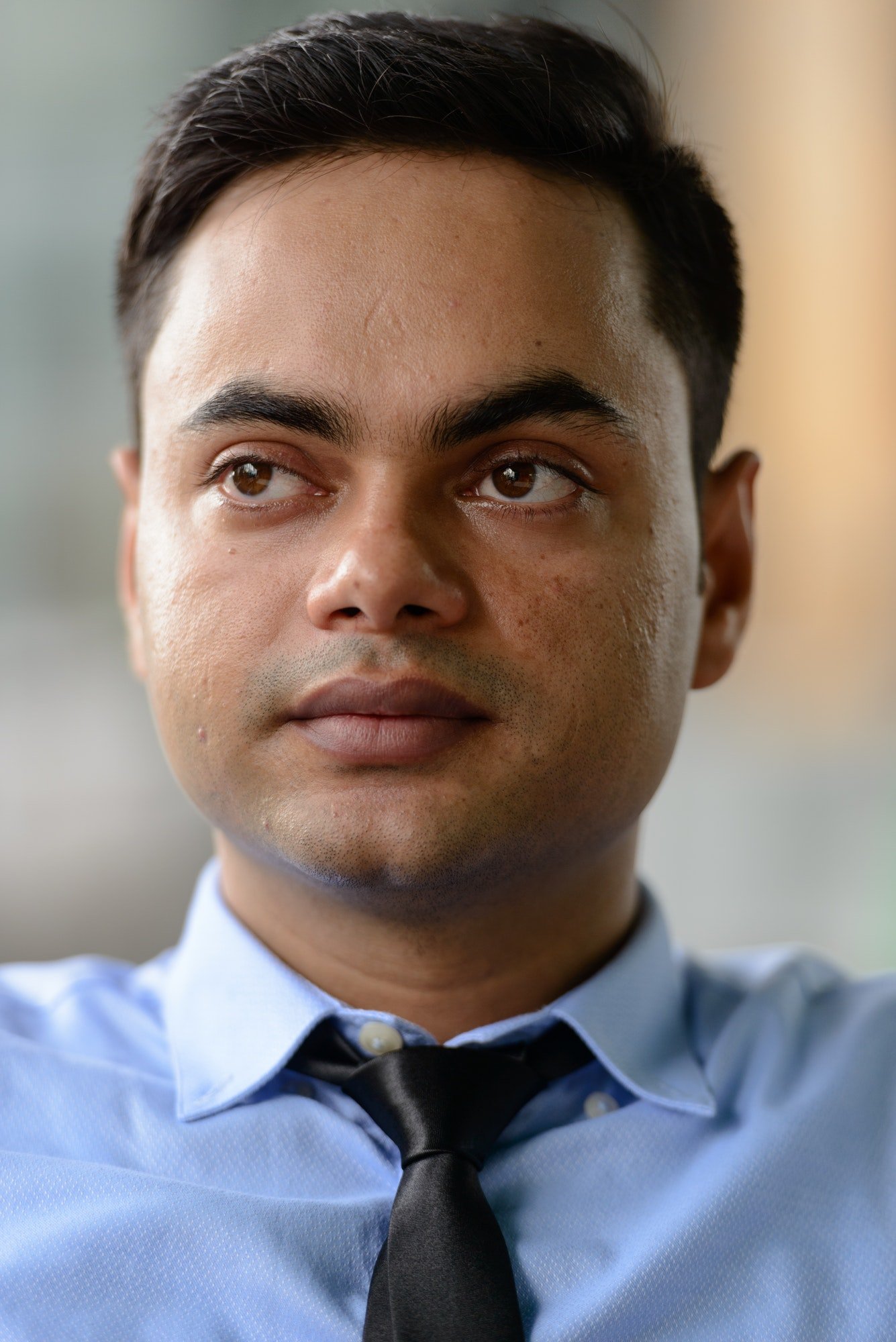 Young handsome Indian businessman in the city