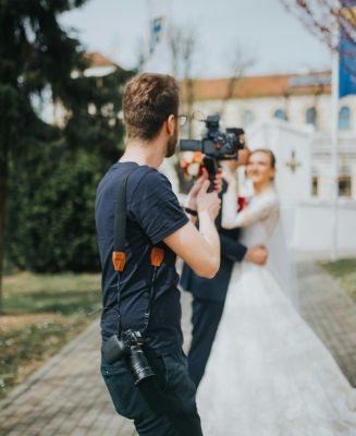 Shallow focus shot of a wedding photographer takes pictures of the bride and groom